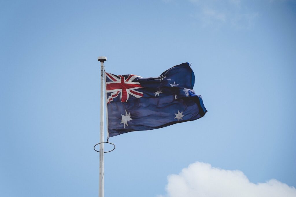 Flag of australia in a blue sky in Best Countries To Live With HIV 