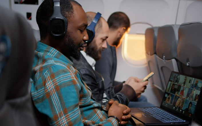 Man using laptop while on flight